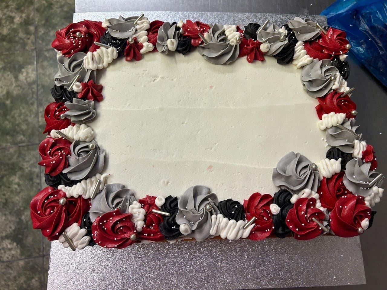 Buttercream icing cake design with floral edge red and black modern sheet cake for party Doreens Bakery