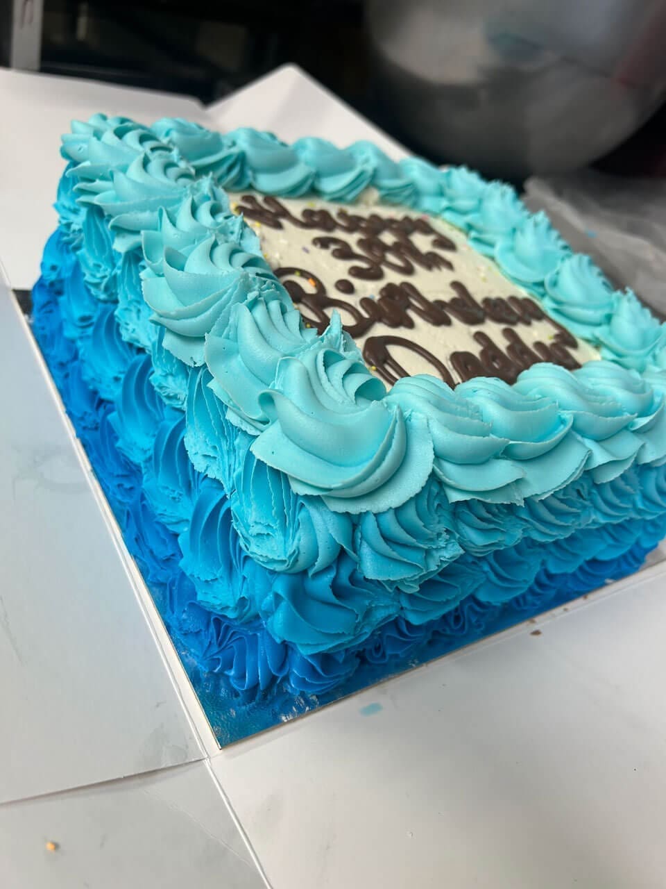 Fresh buttercream cake with blue coloured icing and custom decorations Doreens Bakery Meath